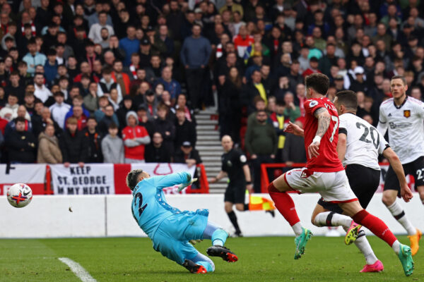 Manchester United's Portuguese defender Diogo Dalot (2R) shoots past Nottingham Forest's Costa Rican goalkeeper Keylor Navas to score their second goal during the English Premier League football match between Nottingham Forest and Manchester United at The City Ground in Nottingham, central England, on April 16, 2023. (Photo by DARREN STAPLES / AFP) / RESTRICTED TO EDITORIAL USE. No use with unauthorized audio, video, data, fixture lists, club/league logos or 'live' services. Online in-match use limited to 120 images. An additional 40 images may be used in extra time. No video emulation. Social media in-match use limited to 120 images. An additional 40 images may be used in extra time. No use in betting publications, games or single club/league/player publications. / 