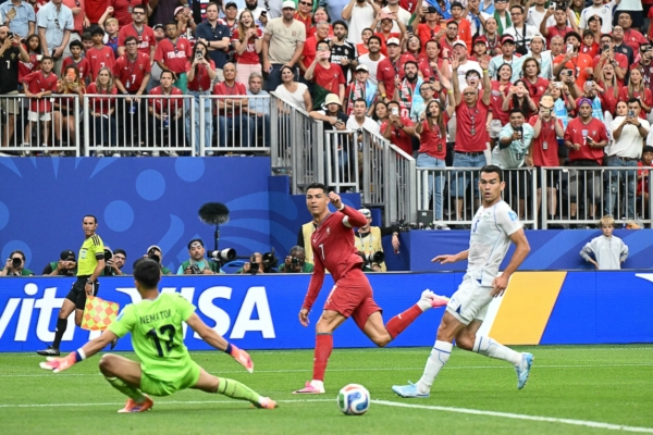 Portugal's forward #07 Cristiano Ronaldo (C) reacts as he scores his team's third goal during the 2026 World Cup Group K football match between Portugal and Uzbekistan at the Houston Stadium in Houston on June 23, 2026. Scotland and Brazil will meet in a 2026 World Cup Group C football match at the Miami Stadium in Miami Gardens on June 24, 2026.