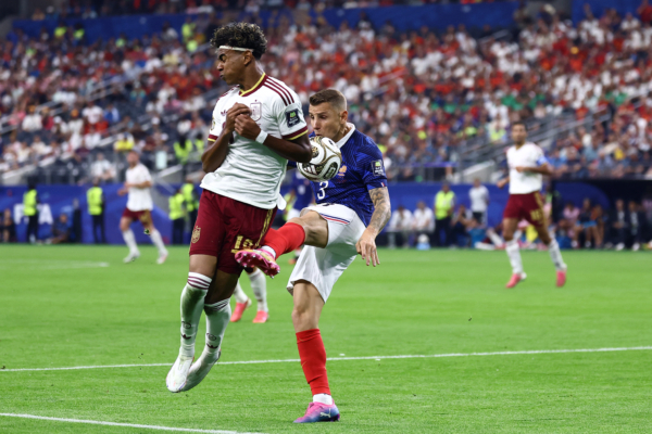 France's defender #03 Lucas Digne fouls Spain's forward #19 Lamine Yamal during the 2026 World Cup football tournament semi-final match between France and Spain at the Dallas Stadium in Arlington on July 14, 2026.