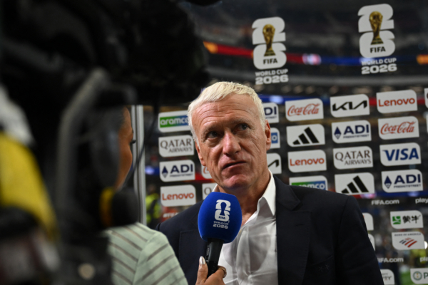 France's head coach Didier Deschamps speaks with a sports broadcaster after his team lost the 2026 World Cup football tournament semi-final match between France and Spain at the Dallas Stadium in Arlington on July 14, 2026.